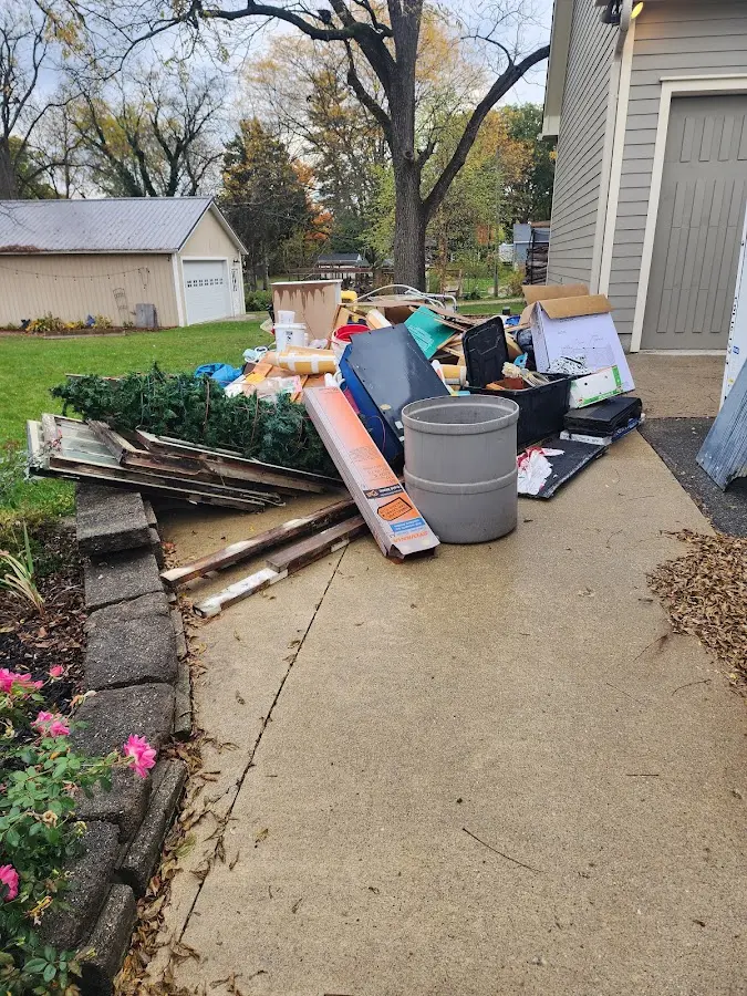 Dumpster being loaded with debris for 3 Yard Dumpster Rental in Tysons
